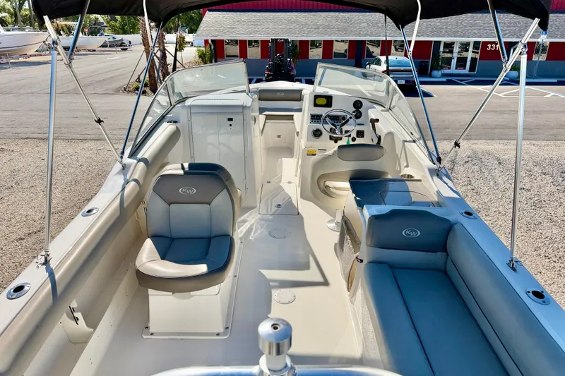 Slide: The Image of 2023 Key West 239 DFS boat interior with seating and steering console. - 12