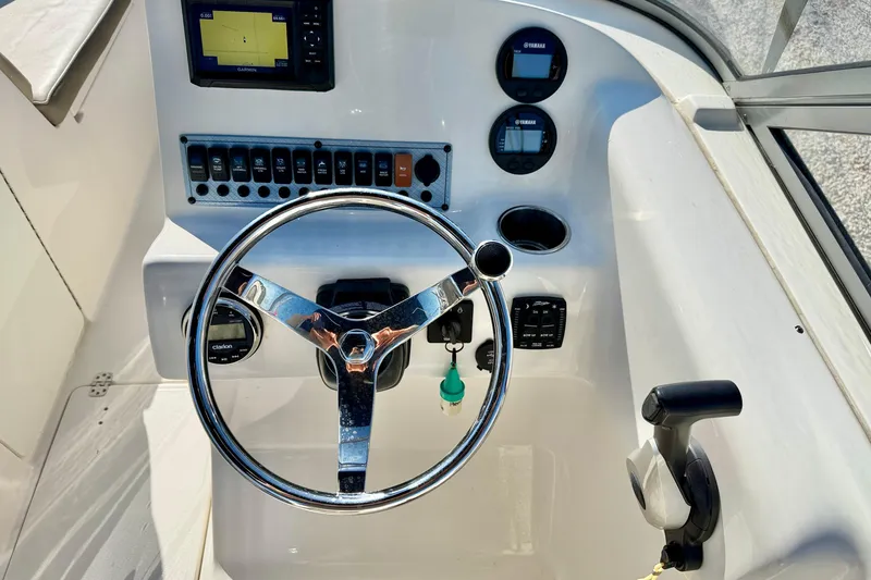 Slide: The Image of Steering console of 2023 Key West 239 DFS boat with navigation controls. - 15