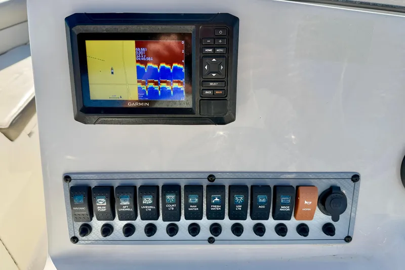 Slide: The Image of Control panel of 2023 Key West 239 DFS boat with Garmin display and switches. - 16