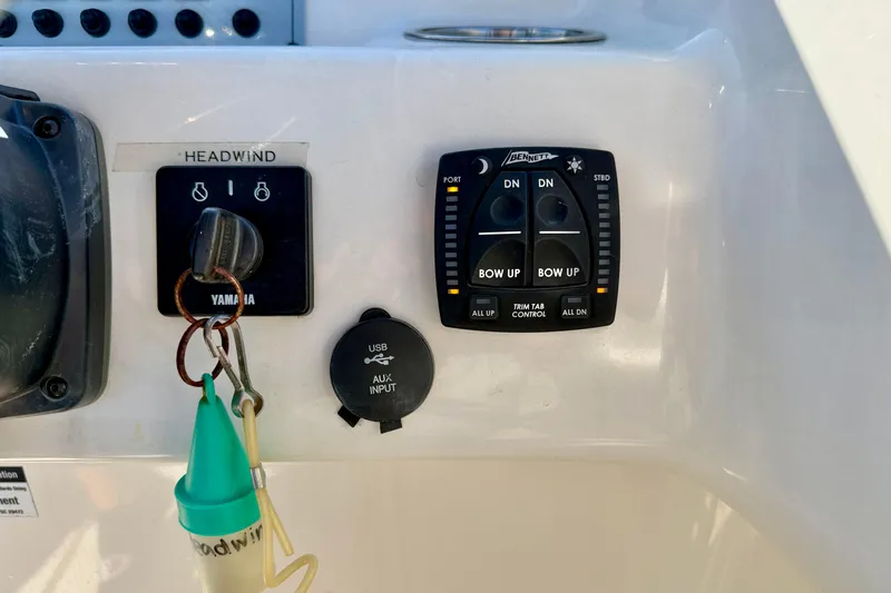 Slide: The Image of Control panel of 2023 Key West 239 DFS boat with Yamaha ignition and trim tab controls. - 20