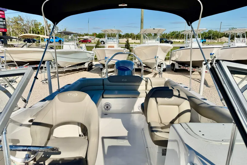 Slide: The Image of 2023 Key West 239 DFS boat interior with seating and canopy, displayed outdoors. - 21