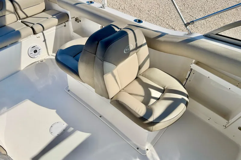 Slide: The Image of 2023 Key West 239 DFS boat interior with beige seating and speaker. - 22