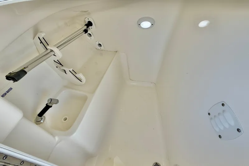 Slide: The Image of 2023 Key West 239 DFS boat interior with fresh water faucet and storage area. - 33