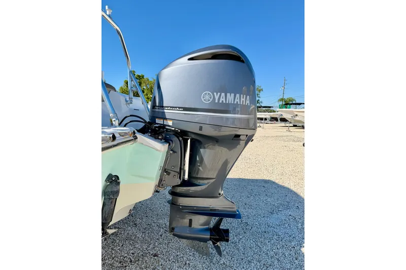 Slide: The Image of 2023 Key West 239 DFS boat with Yamaha outboard motor in a sunny outdoor setting. - 34