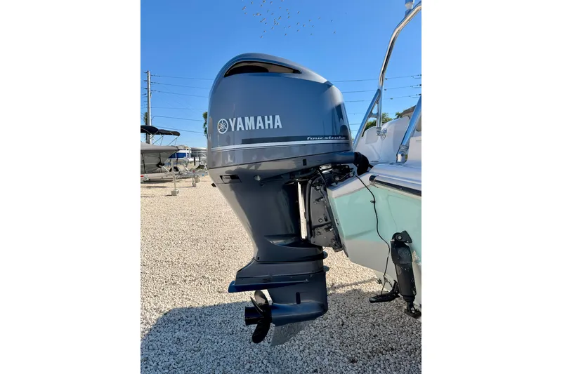 Slide: The Image of Yamaha outboard motor on 2023 Key West 239 DFS boat, parked on gravel. - 36