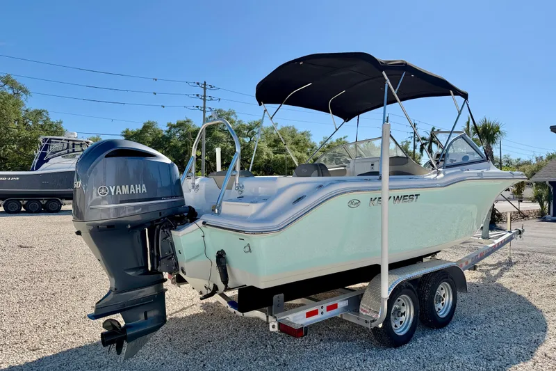 Slide: The Image of 2023 Key West 239 DFS boat with Yamaha engine on trailer, parked outdoors. - 5