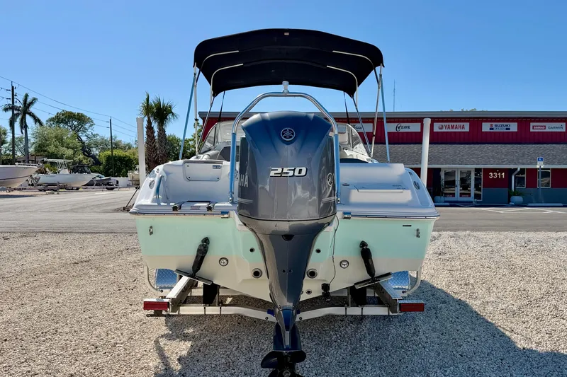 Slide: The Image of 2023 Key West 239 DFS boat with Yamaha 250 engine, parked on gravel. - 6