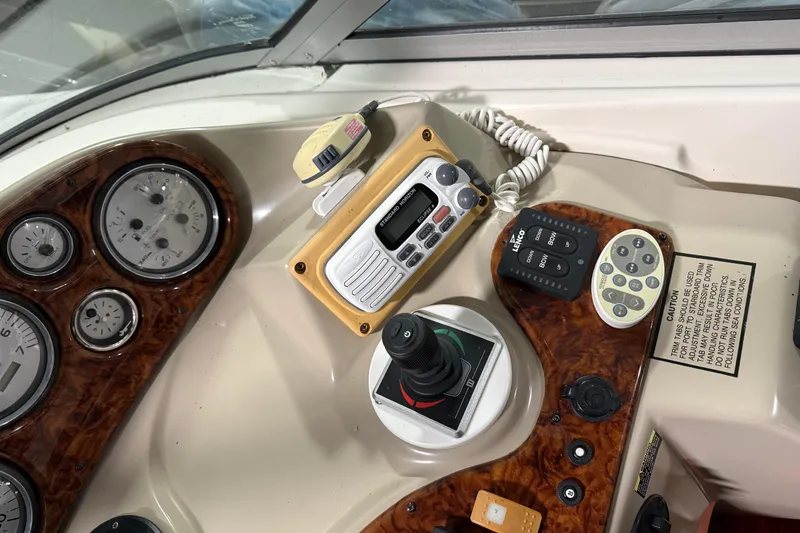 Slide: The Image of Control panel of a 2003 Rinker 342 Express Cruiser with gauges and navigation equipment. - 3