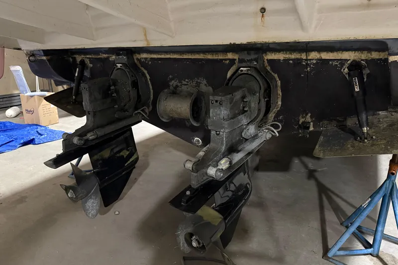 Slide: The Image of 2003 Rinker 342 Express Cruiser stern drive components in a garage setting. - 5