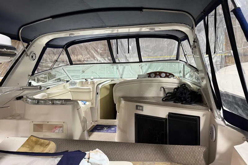 Slide: The Image of Interior view of a 2003 Rinker 342 Express Cruiser boat, featuring seating and dashboard. - 2