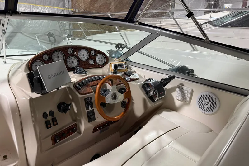 Slide: The Image of 2003 Rinker 342 Express Cruiser cockpit with Garmin navigation system and wooden steering wheel. - 4
