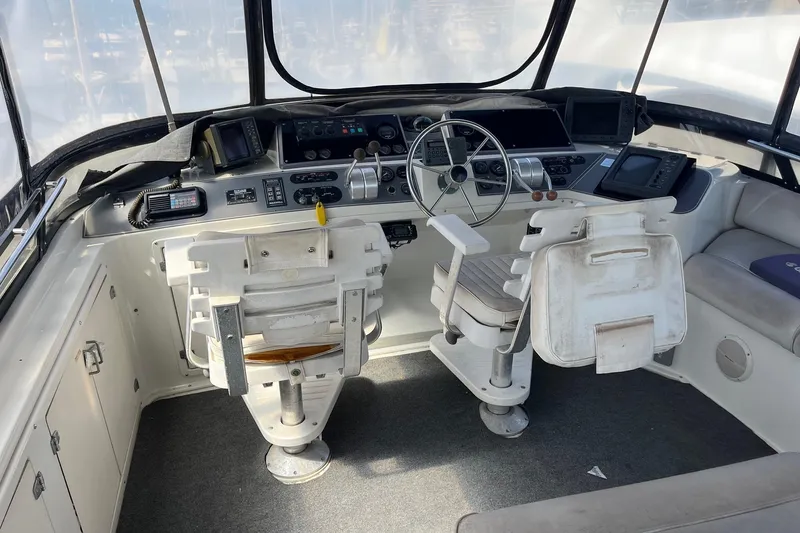 Slide: The Image of Cockpit of a 1990 Californian 52 Cockpit Motor Yacht with dual helm chairs and navigation equipment. - 15