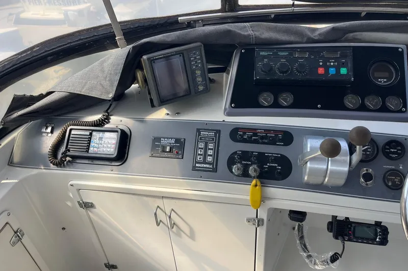 Slide: The Image of Control panel of a 1990 Californian 52 Cockpit Motor Yacht with navigation instruments. - 16