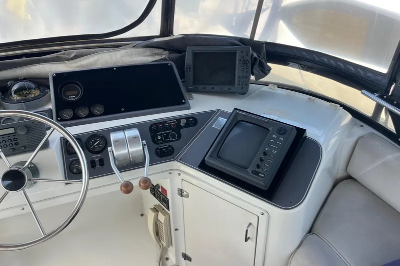 Slide: The Image of Cockpit of 1990 Californian 52 Cockpit Motor Yacht with navigation equipment and steering wheel. - 17