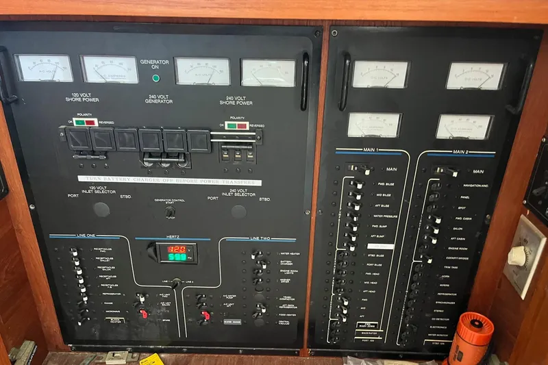 Slide: The Image of Electrical control panel of a 1990 Californian 52 Cockpit Motor Yacht, featuring gauges and switches. - 18