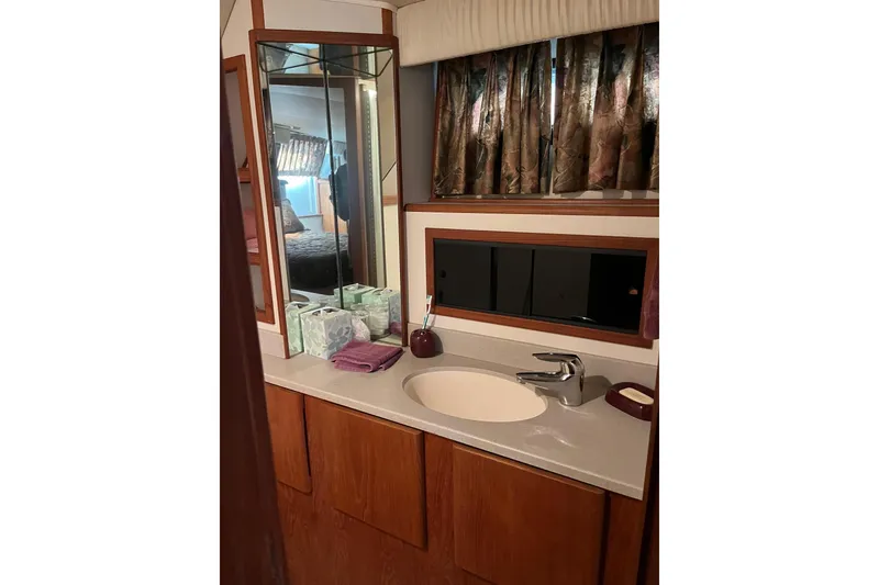 Slide: The Image of Bathroom vanity in 1990 Californian 52 Cockpit Motor Yacht with mirror and sink. - 4