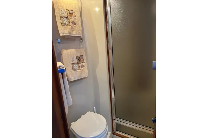 Slide: The Image of Bathroom in 1990 Californian 52 Cockpit Motor Yacht with shower and decorative towels. - 7