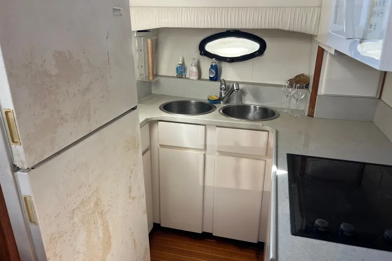 Slide: The Image of 1990 Californian 52 Cockpit Motor Yacht kitchen with dual sinks and appliances. - 9