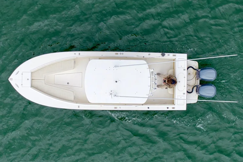 Slide: The Image of Overhead view of 2003 Regulator 26 Forward Seating boat on green water. - 11