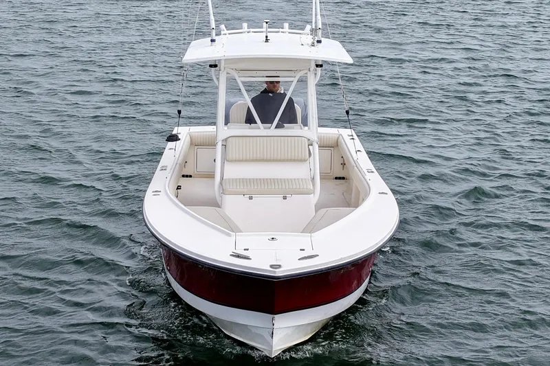 Slide: The Image of 2003 Regulator 26 Forward Seating boat on water, viewed from front. - 12
