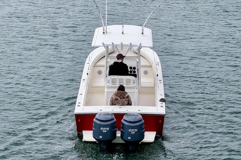 Slide: The Image of 2003 Regulator 26 Forward Seating boat with dual 225 V6 engines on water. - 13