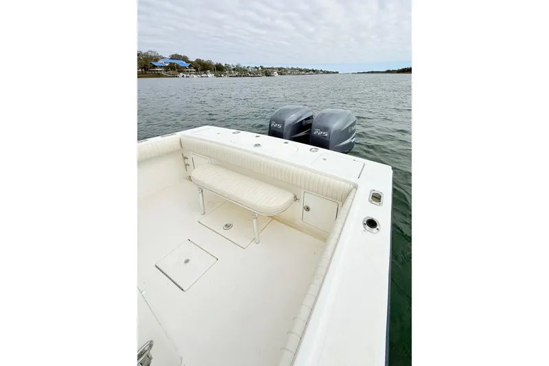 Slide: The Image of 2003 Regulator 26 Forward Seating boat with twin Yamaha 225 engines on calm water. - 19