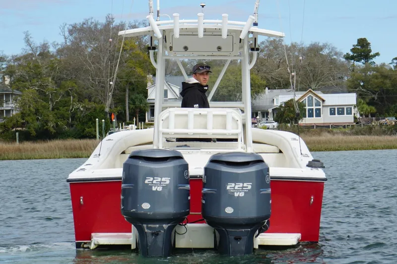 Slide: The Image of Red 2003 Regulator 26 Forward Seating boat with dual 225 V6 engines on water. - 6