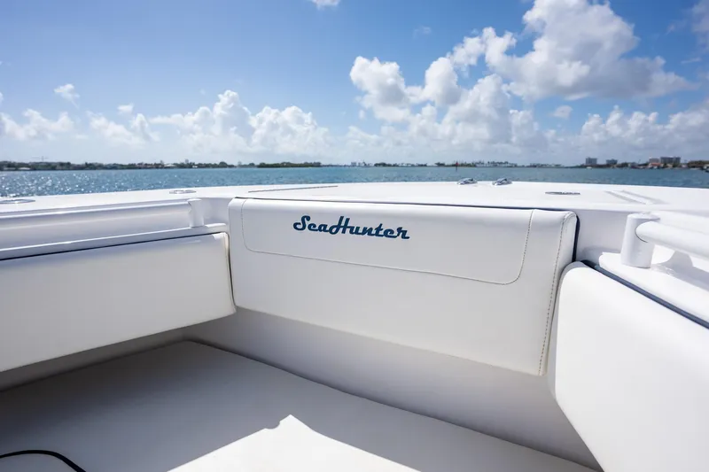 Slide: The Image of 2016 SeaHunter 45 boat interior with white seating, ocean view, and blue sky. - 13