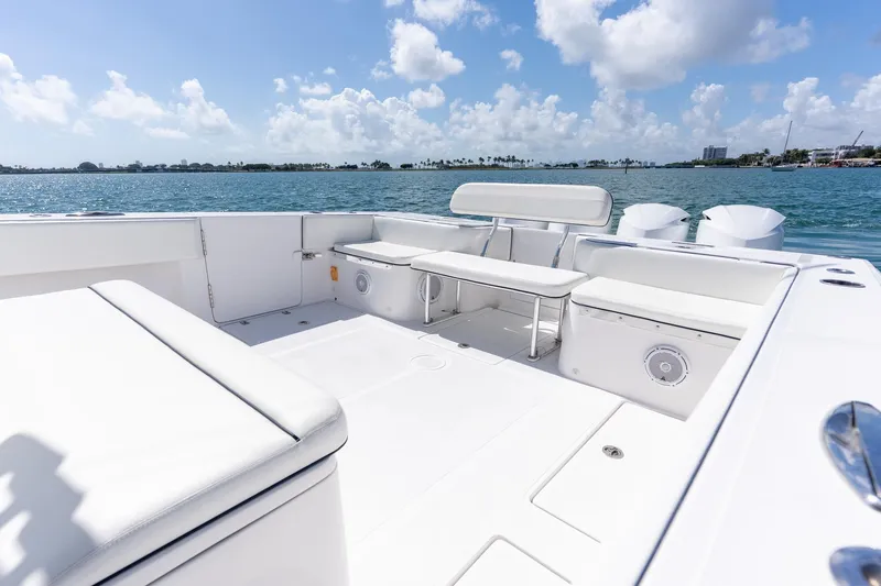 Slide: The Image of Spacious deck of 2016 SeaHunter 45 boat with seating, overlooking calm waters and blue sky. - 18