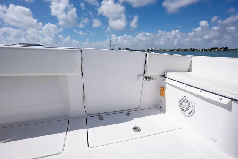 Slide: The Image of Interior view of 2016 SeaHunter 45 boat, featuring sleek white seating and ocean backdrop. - 19