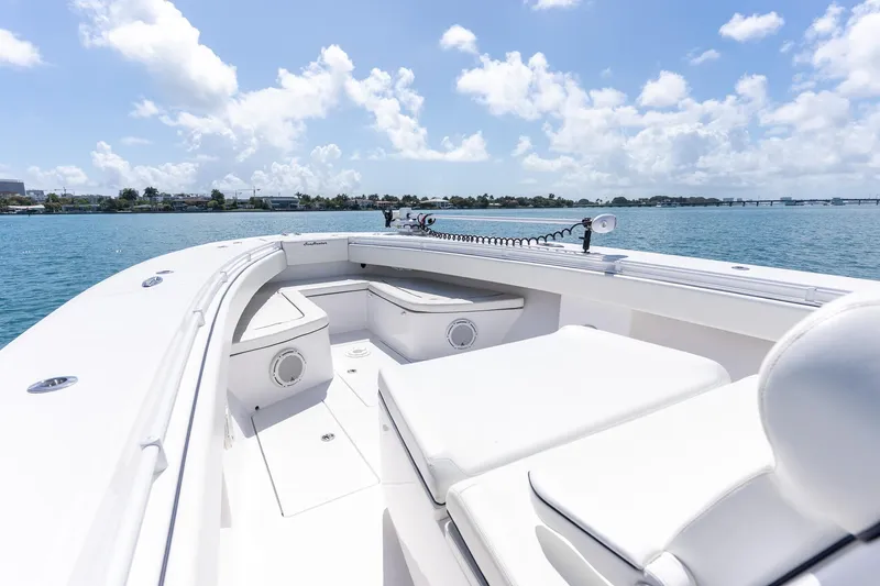 Slide: The Image of 2016 SeaHunter 45 boat deck with seating, under a clear blue sky on calm waters. - 20