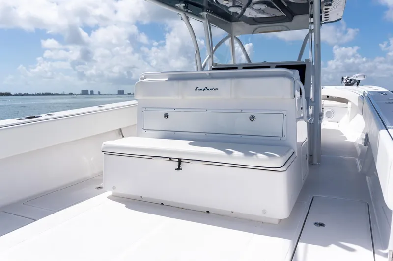 Slide: The Image of 2016 SeaHunter 45 boat interior with seating, under a clear blue sky. - 22