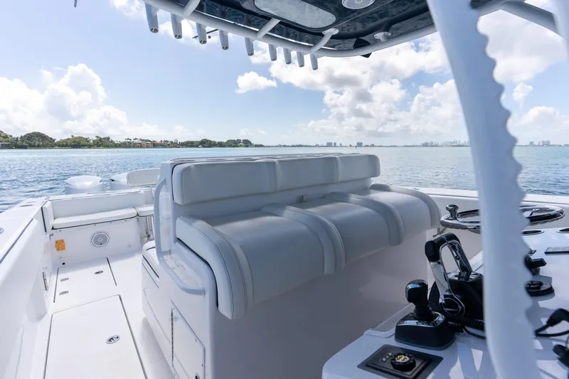 Slide: The Image of Interior view of 2016 SeaHunter 45 boat with seating and controls, overlooking calm waters. - 23