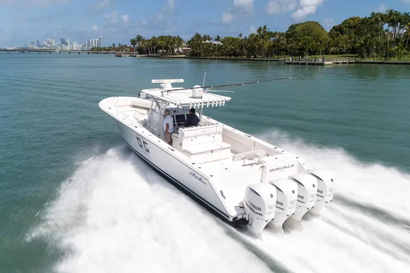 Slide: The Image of 2016 SeaHunter 45 boat cruising on clear waters near a tropical shoreline. - 7