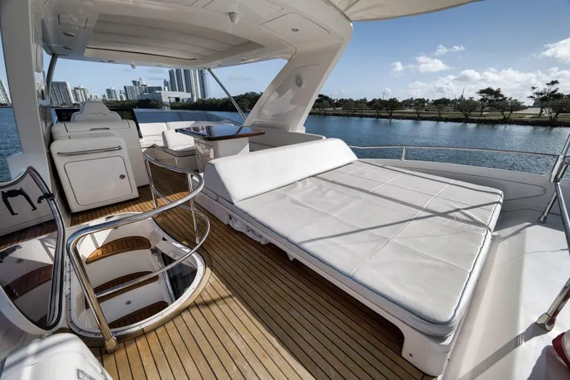 Slide: The Image of Luxurious 2012 Azimut 64 yacht deck with sunbed and scenic waterfront view. - 10