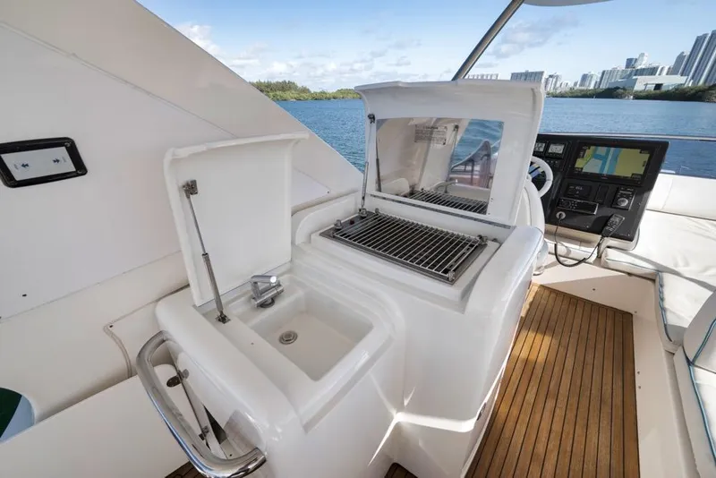 Slide: The Image of Luxurious 2012 Azimut 64 yacht interior with sink, grill, and navigation controls. - 12