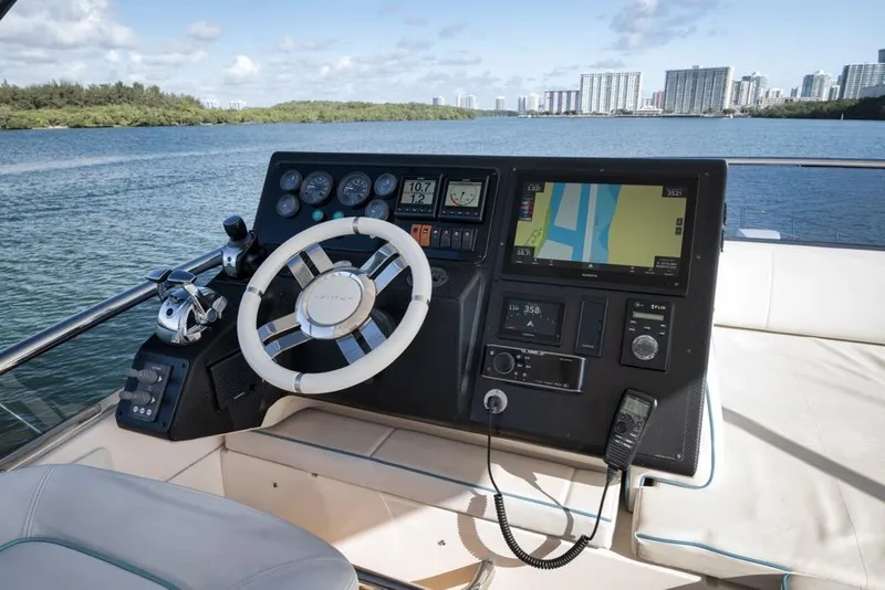 Slide: The Image of Cockpit of 2012 Azimut 64 yacht with navigation controls and city skyline view. - 13