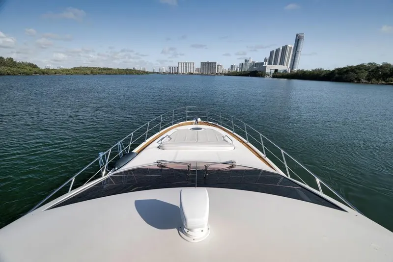 Slide: The Image of Front view of 2012 Azimut 64 yacht cruising towards city skyline. - 14
