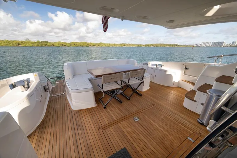 Slide: The Image of Luxurious 2012 Azimut 64 yacht deck with seating, overlooking serene waters. - 16
