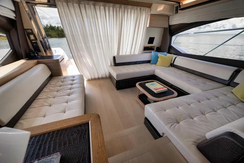Slide: The Image of Luxurious interior of a 2012 Azimut 64 yacht with elegant seating and scenic views. - 18