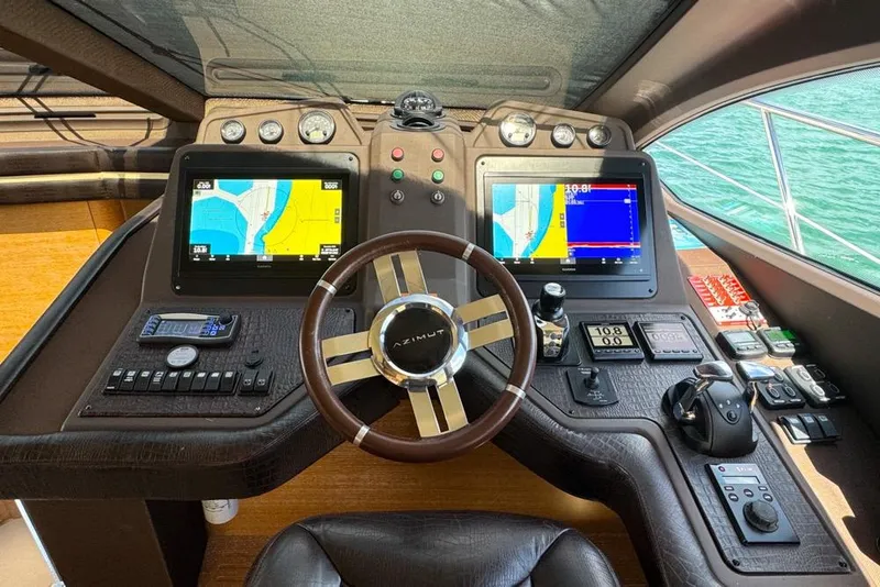 Slide: The Image of Cockpit of 2012 Azimut 64 yacht with navigation screens and controls. - 23