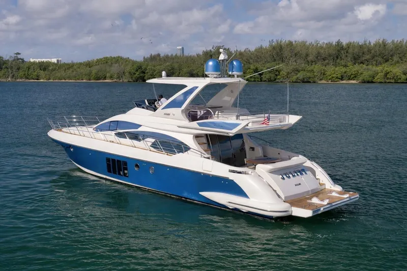 Slide: The Image of Luxurious 2012 Azimut 64 yacht cruising on serene waters under a partly cloudy sky. - 3