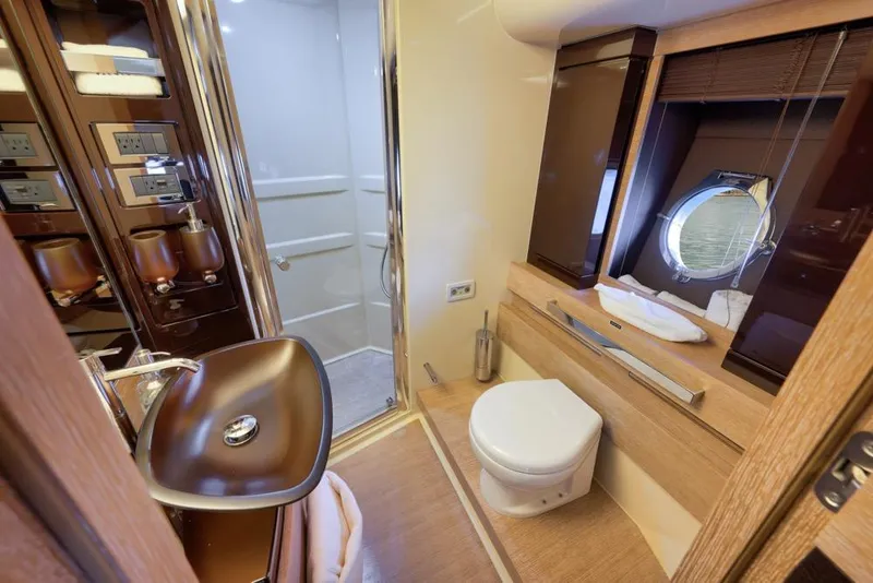 Slide: The Image of Luxurious bathroom in a 2012 Azimut 64 yacht, featuring modern fixtures and elegant design. - 31