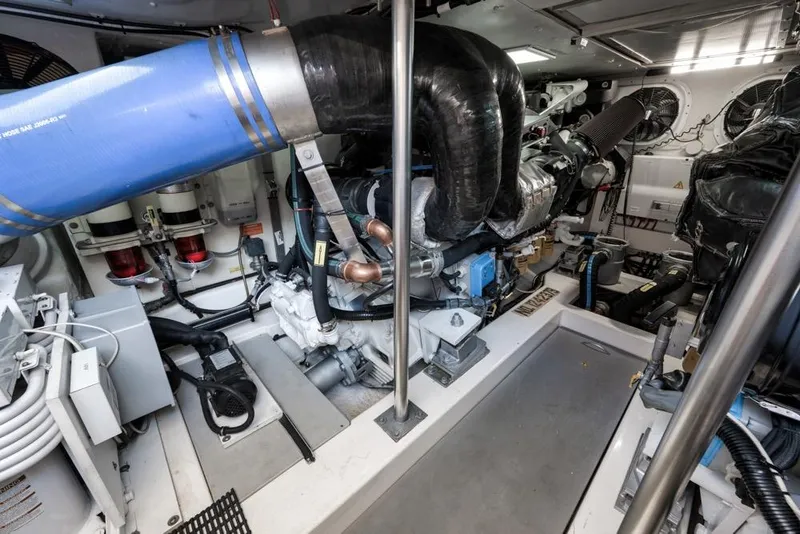 Slide: The Image of Engine room of a 2012 Azimut 64 yacht, showcasing mechanical components and systems. - 42