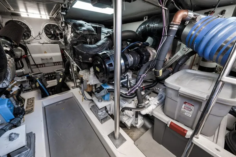 Slide: The Image of Engine room of a 2012 Azimut 64 yacht, showcasing mechanical components and storage. - 43