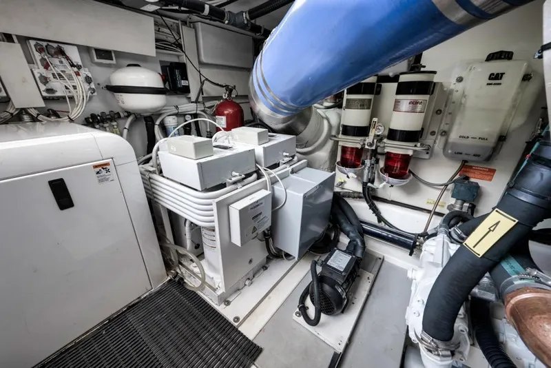 Slide: The Image of Engine room of a 2012 Azimut 64 yacht, showcasing mechanical components and systems. - 45