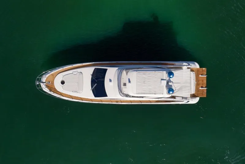 Slide: The Image of Aerial view of 2012 Azimut 64 yacht on calm green water. - 46