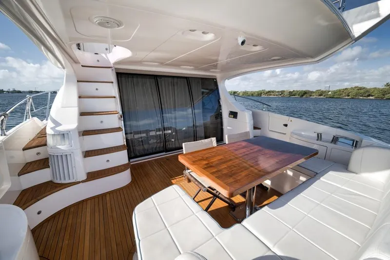 Slide: The Image of Luxurious 2012 Azimut 64 yacht deck with elegant seating and wooden table. - 7