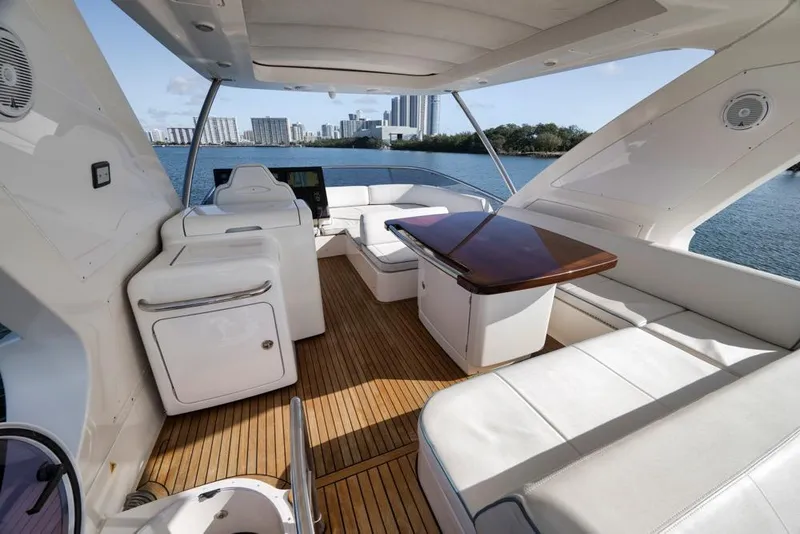 Slide: The Image of Luxurious 2012 Azimut 64 yacht interior with elegant seating and scenic waterfront view. - 8