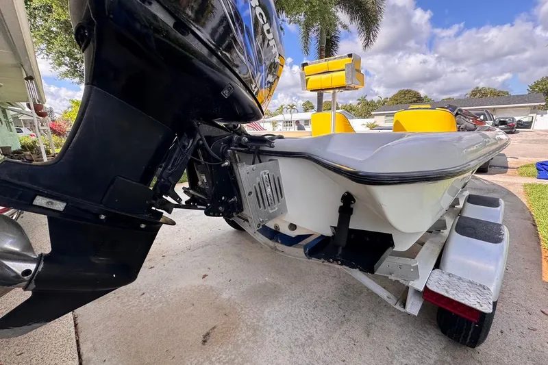 Slide: The Image of 2005 Storm Boats Storm-High Performance on trailer, featuring powerful outboard motor. - 10
